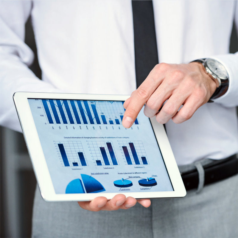 Hand of young elegant economist or analyst in formalwear pointing at financial chart in tablet while making presentation